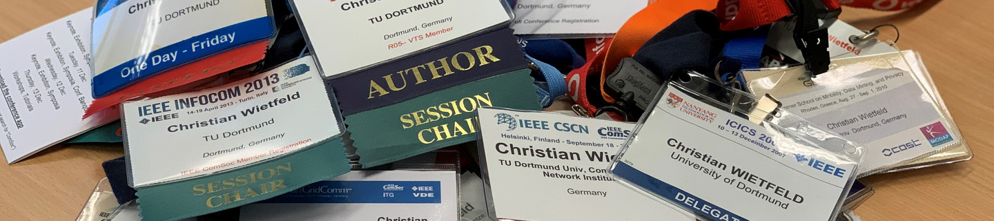 ID cards from conferences on a desk