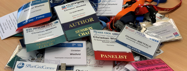 ID cards from conferences on a desk